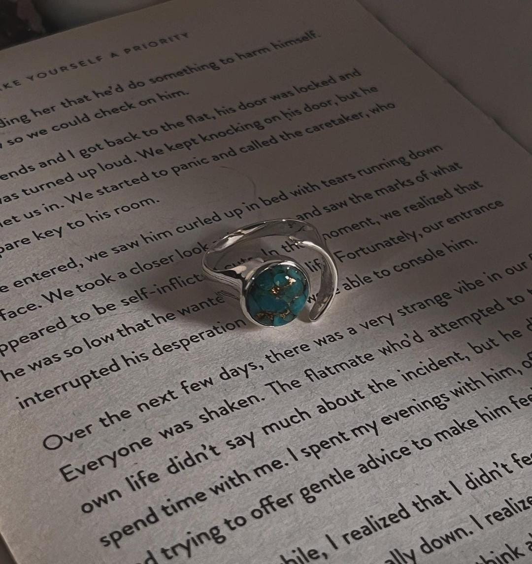 Close-up of copper turquoise moon stone in an adjustable silver ring