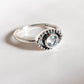 Boho-inspired evil eye silver ring with eye-catching blue topaz gemstone