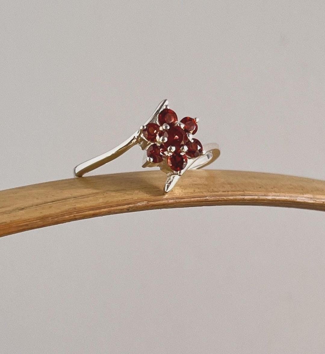 Garnet gemstone flower ring with a striking silver band
