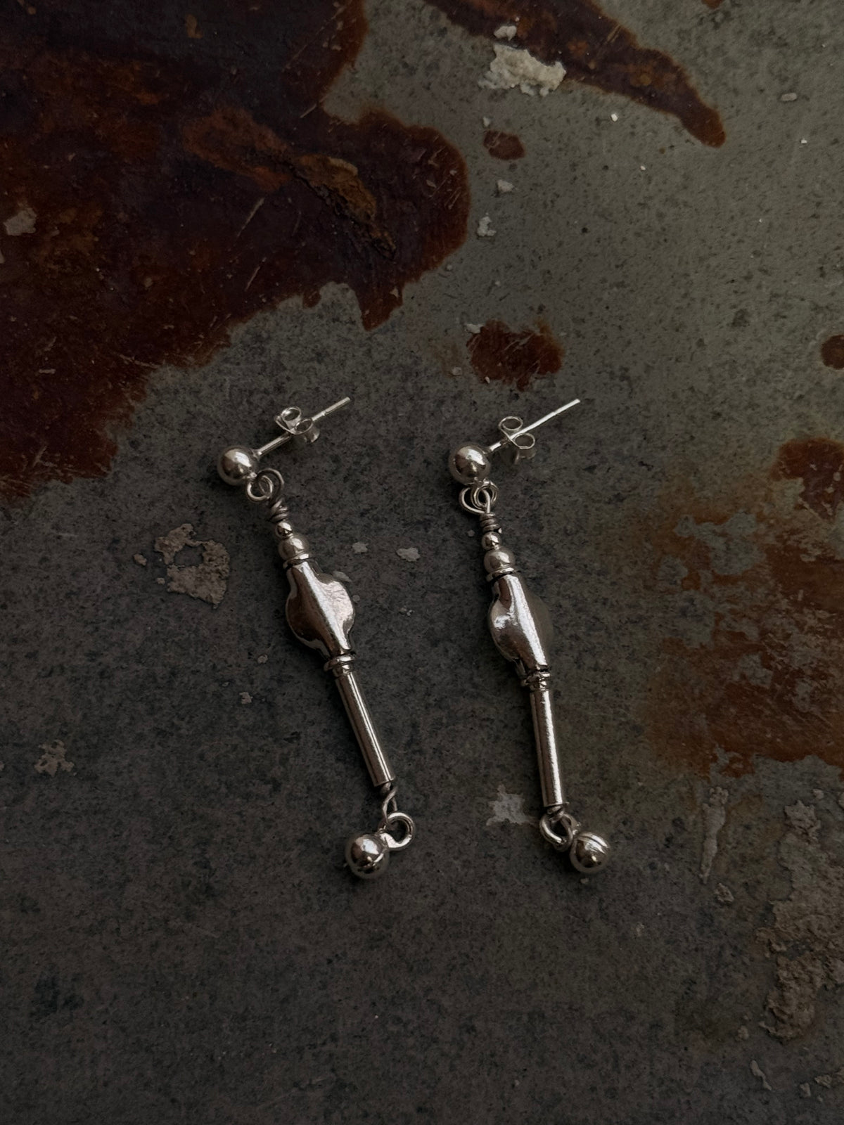 925 Sterling Silver Handcrafted Tribal Contemporary Mandali Earrings on textured background.