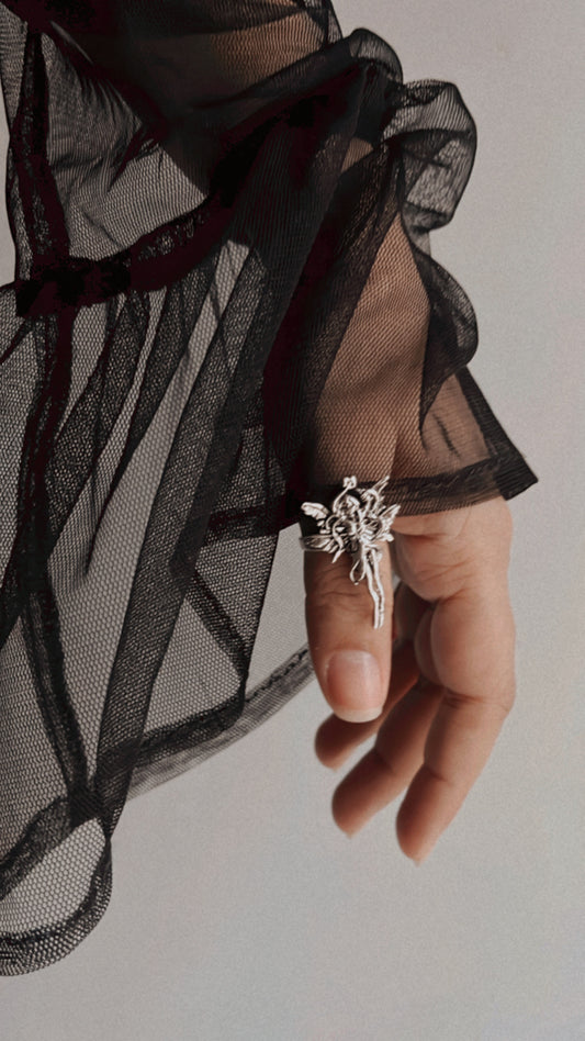 Sterling silver adjustable ring featuring a delicate angel design.