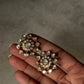 Pair of 925 Sterling Silver Gold Plated Antique Moissanite Polki Earrings held in hand.