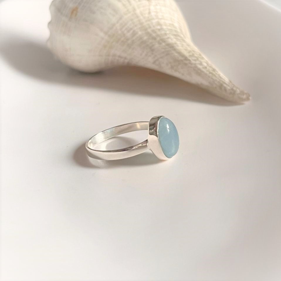 Refined sterling silver ring with a natural oval aquamarine gemstone.
