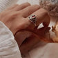 Silver ring featuring a divine lotus design with a garnet center