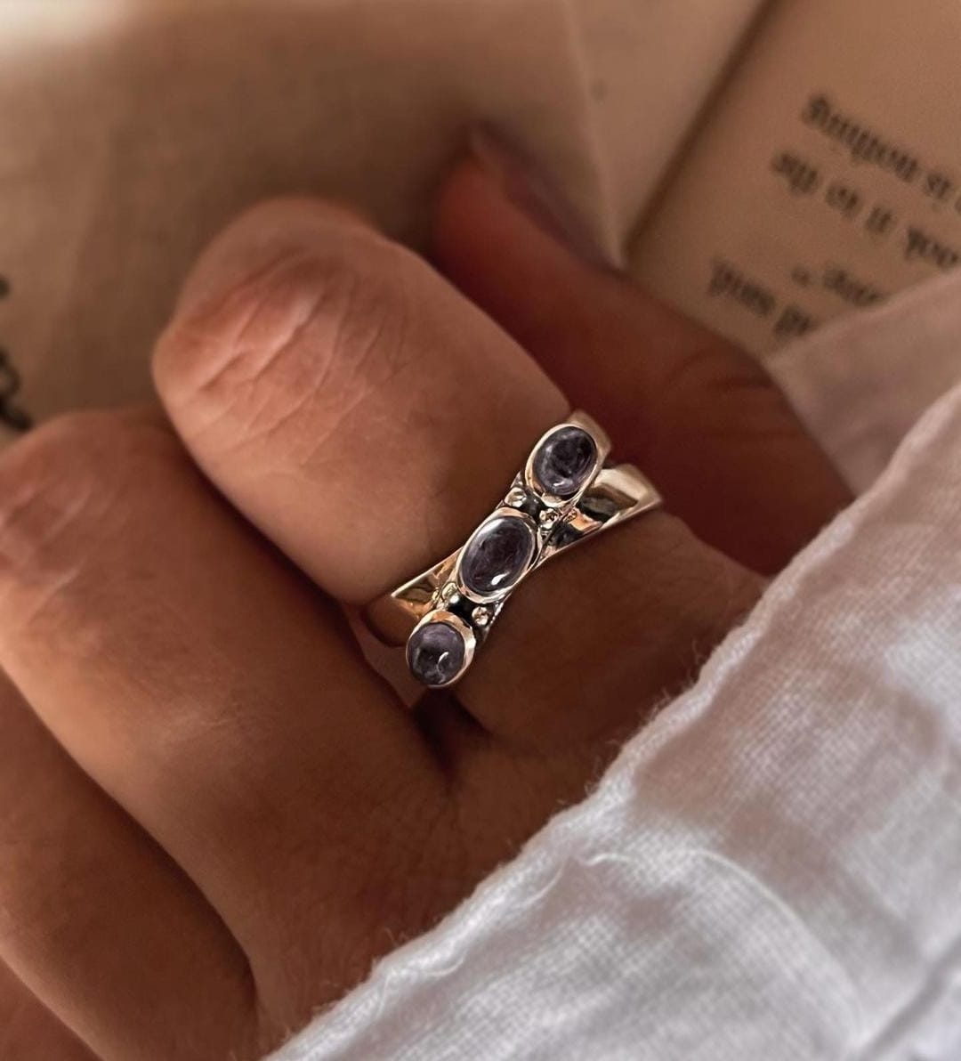 Handcrafted tanzanite cross band ring in sterling silver
