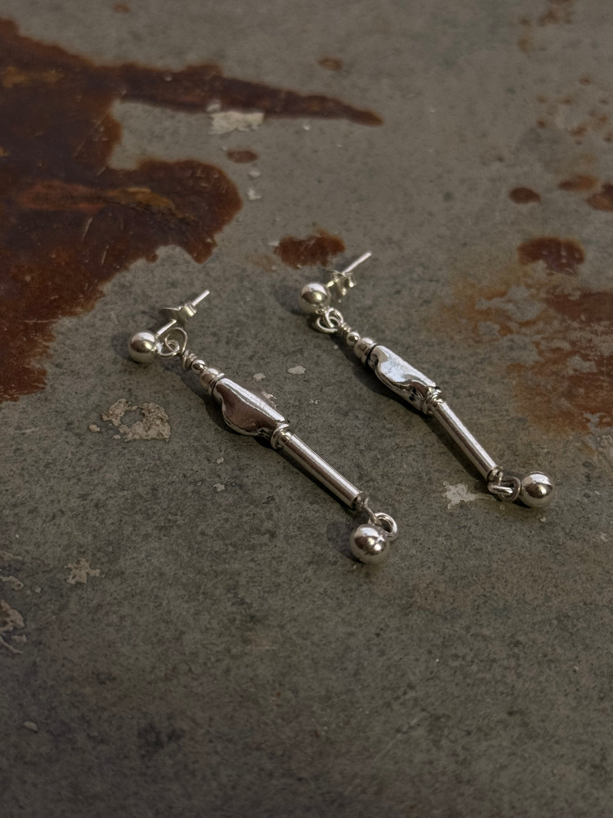925 Sterling Silver Handcrafted Tribal Contemporary Mandali Earrings displayed on a rustic surface.