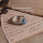 Sleek natural aquamarine oval silver ring with simple elegance.