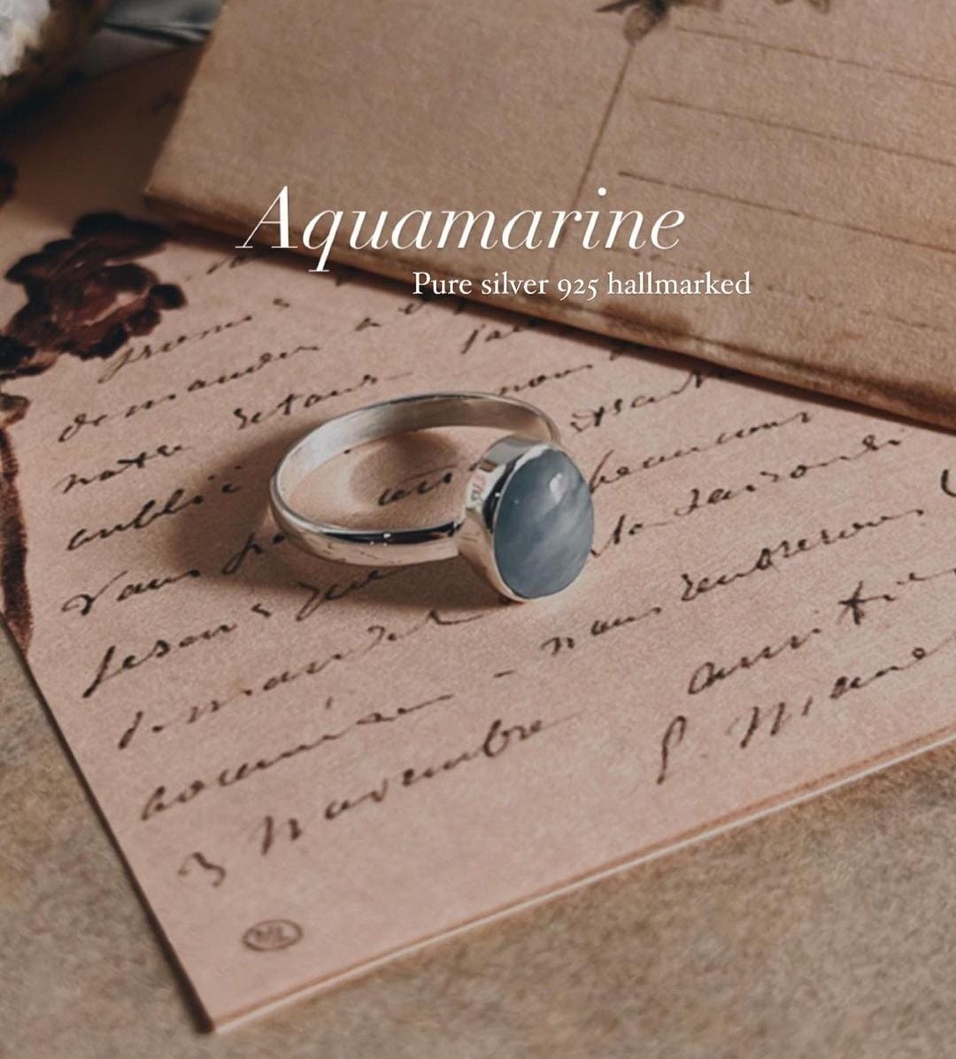 Sleek natural aquamarine oval silver ring with simple elegance.