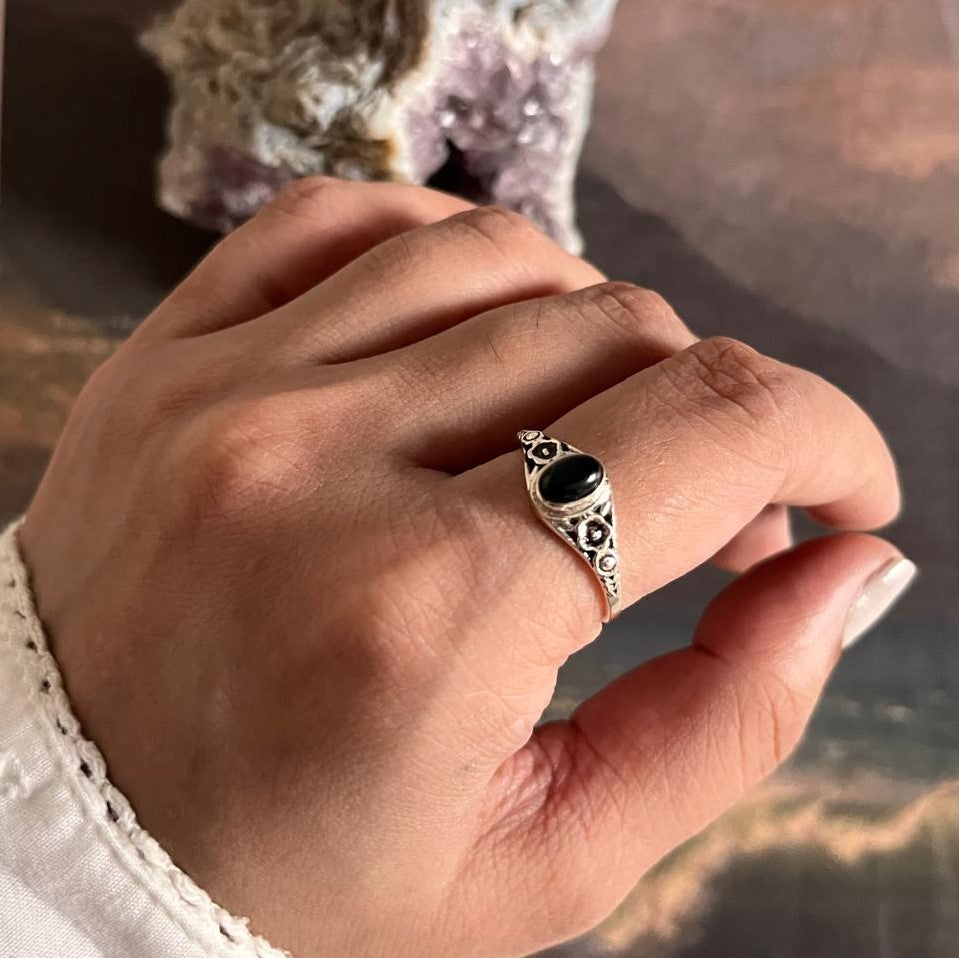 Timeless black onyx stone set in a flower-shaped sterling silver ring.