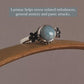 Larimar gemstone set in a silver ring with delicate cherry blossom design