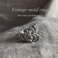 Close-up of chunky band ring with vintage-inspired motif design
