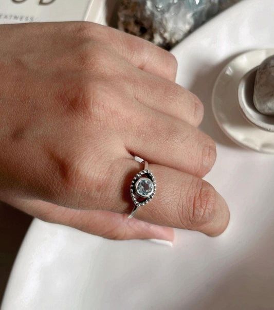 Elegant evil eye boho silver ring featuring a stunning blue topaz