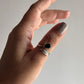Charming black onyx and feather adjustable silver ring for a unique look.