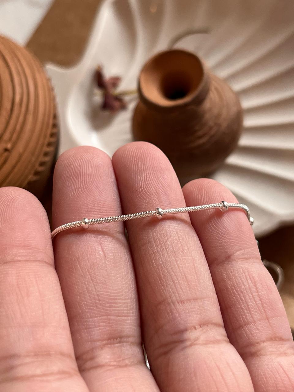 Sleek silver snake chain with subtle dot embellishments