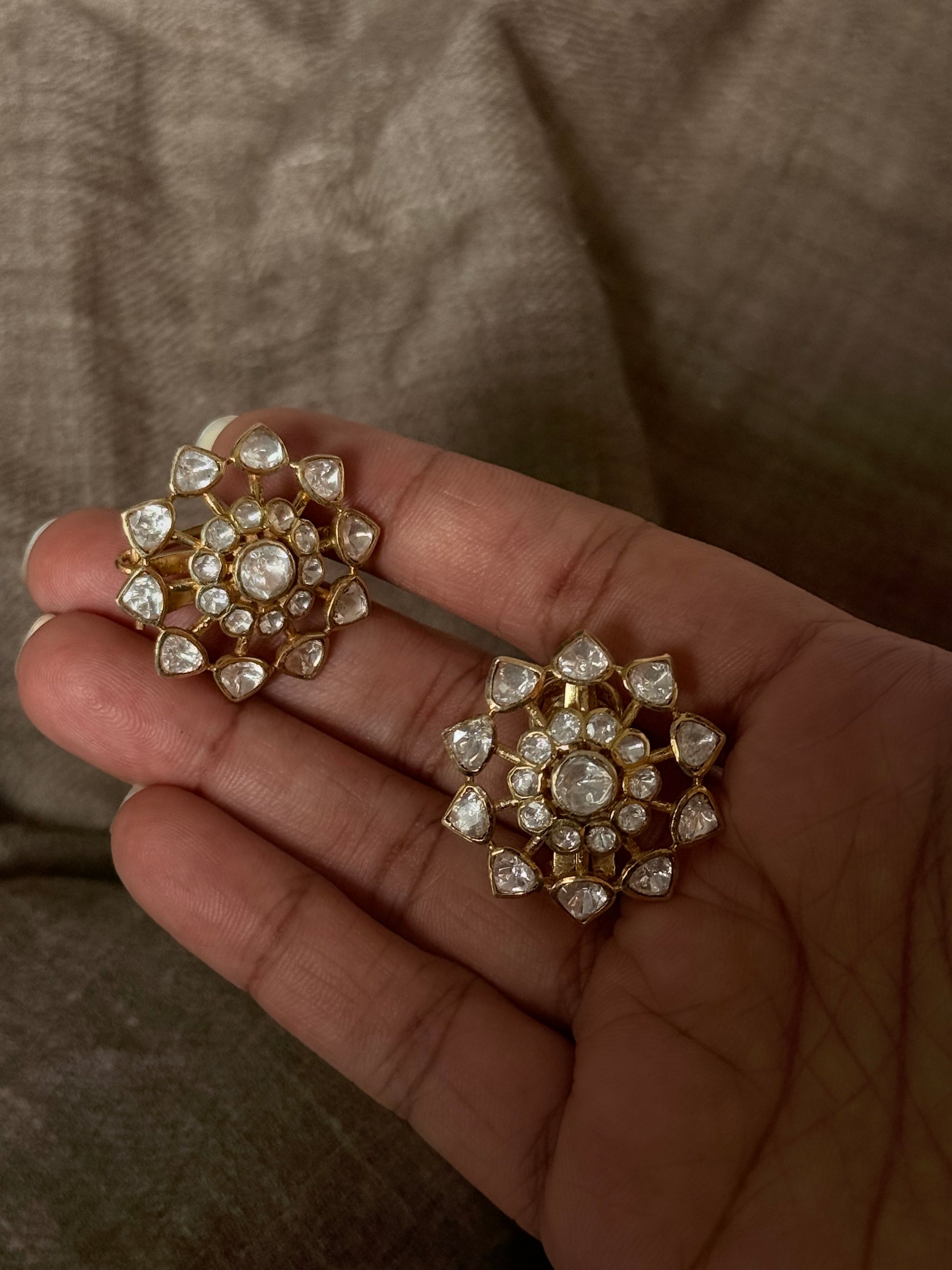 925 Sterling Silver Gold Plated Antique Moissanite Polki Earrings in hand, showcasing floral design and elegance.