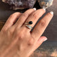 Timeless adjustable silver ring featuring a black onyx stone and feather motif.
