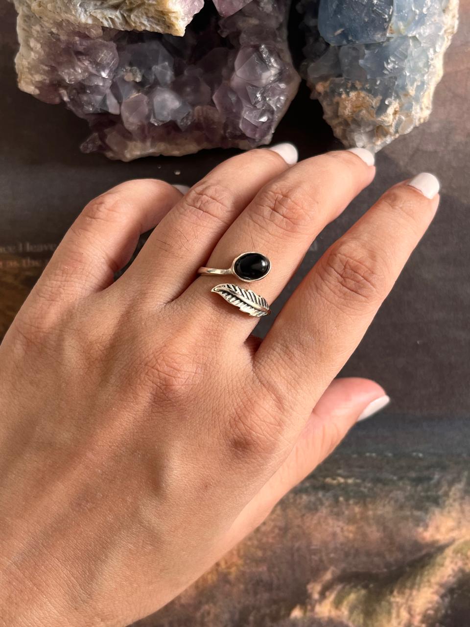 Timeless adjustable silver ring featuring a black onyx stone and feather motif.