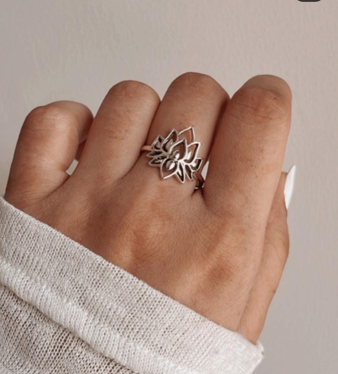 Elegant silver ring with a large, intricate lotus flower design.