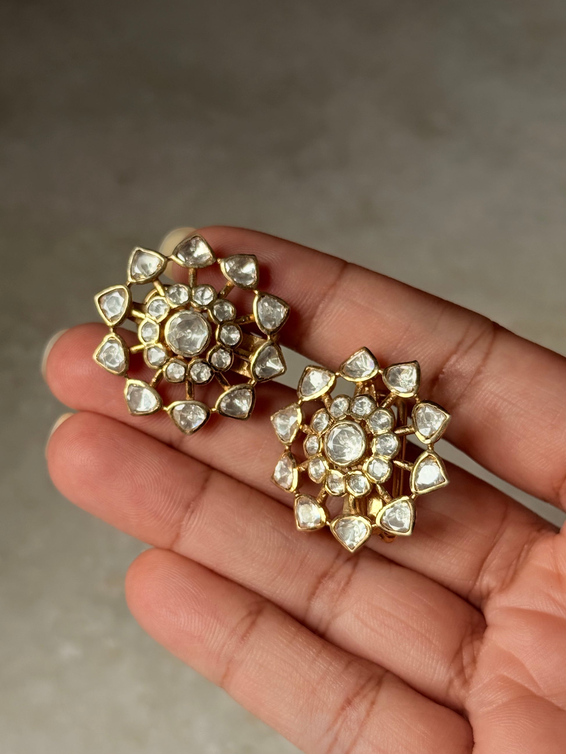 925 Sterling Silver Gold Plated Antique Moissanite Polki Earrings displayed in hand, showcasing floral design and craftsmanship.