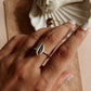 Nature-inspired silver ring featuring a delicate cowrie seashell