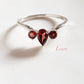 Elegant garnet 3-stone silver ring with pear and round cuts