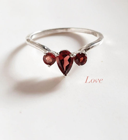 Elegant garnet 3-stone silver ring with pear and round cuts