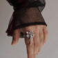 Angel-inspired adjustable sterling silver ring with intricate detailing.