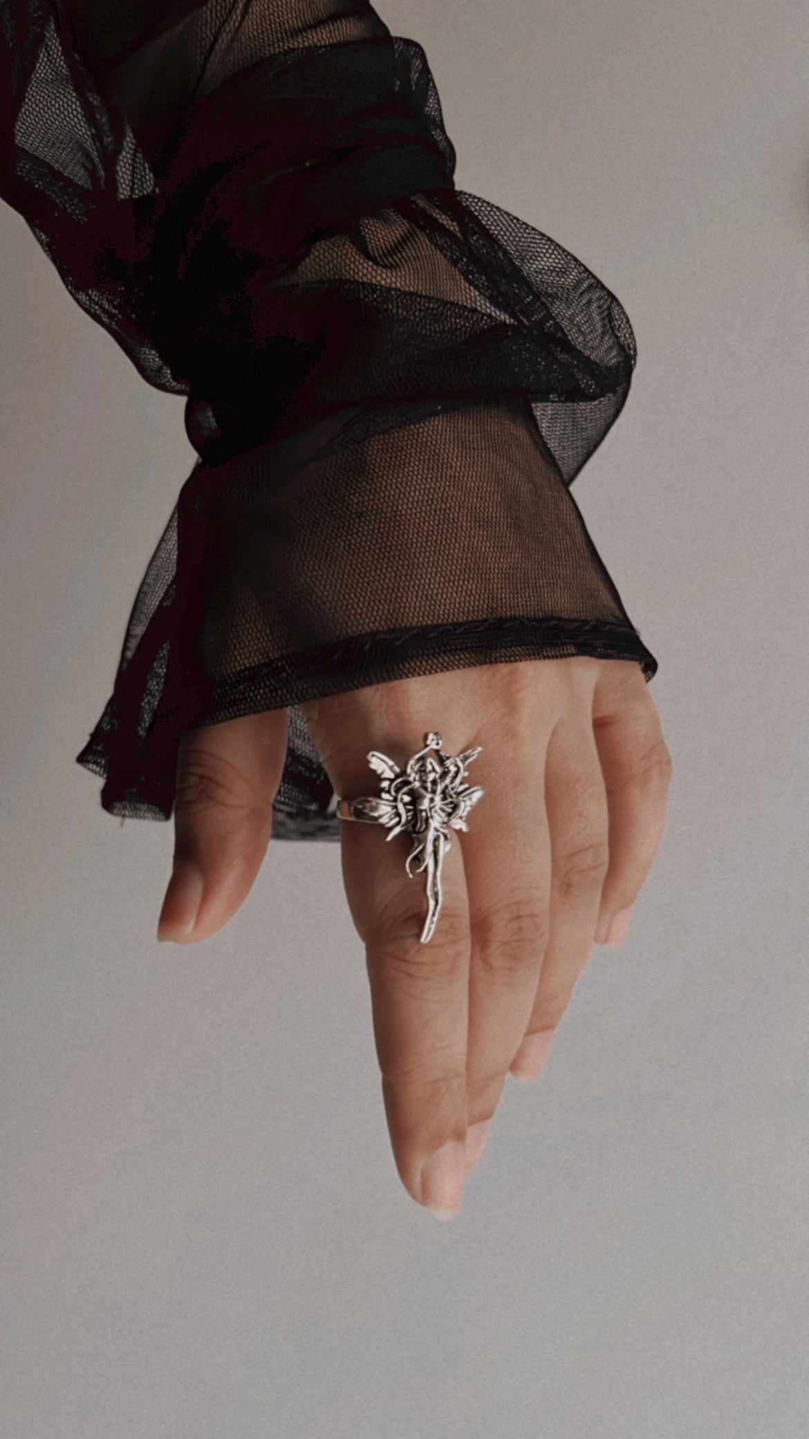Angel-inspired adjustable sterling silver ring with intricate detailing.