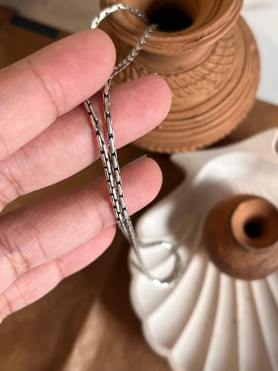 Timeless antique-patterned silver chain for an elegant look.