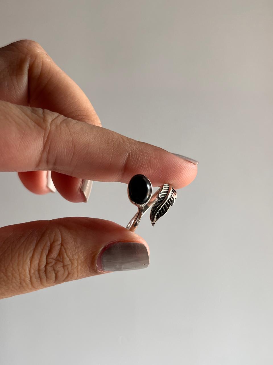 Sophisticated black onyx feather ring in sterling silver with adjustable band.