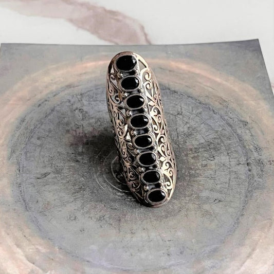 Bold black onyx full finger statement silver ring with striking design.