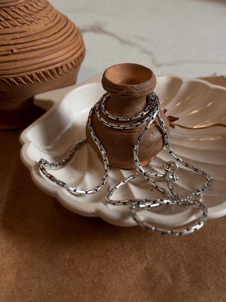 Vintage-style silver chain featuring an antique patterned design.