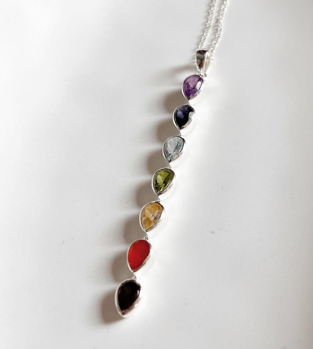 Bold seven chakra statement pendant featuring pear cut stones