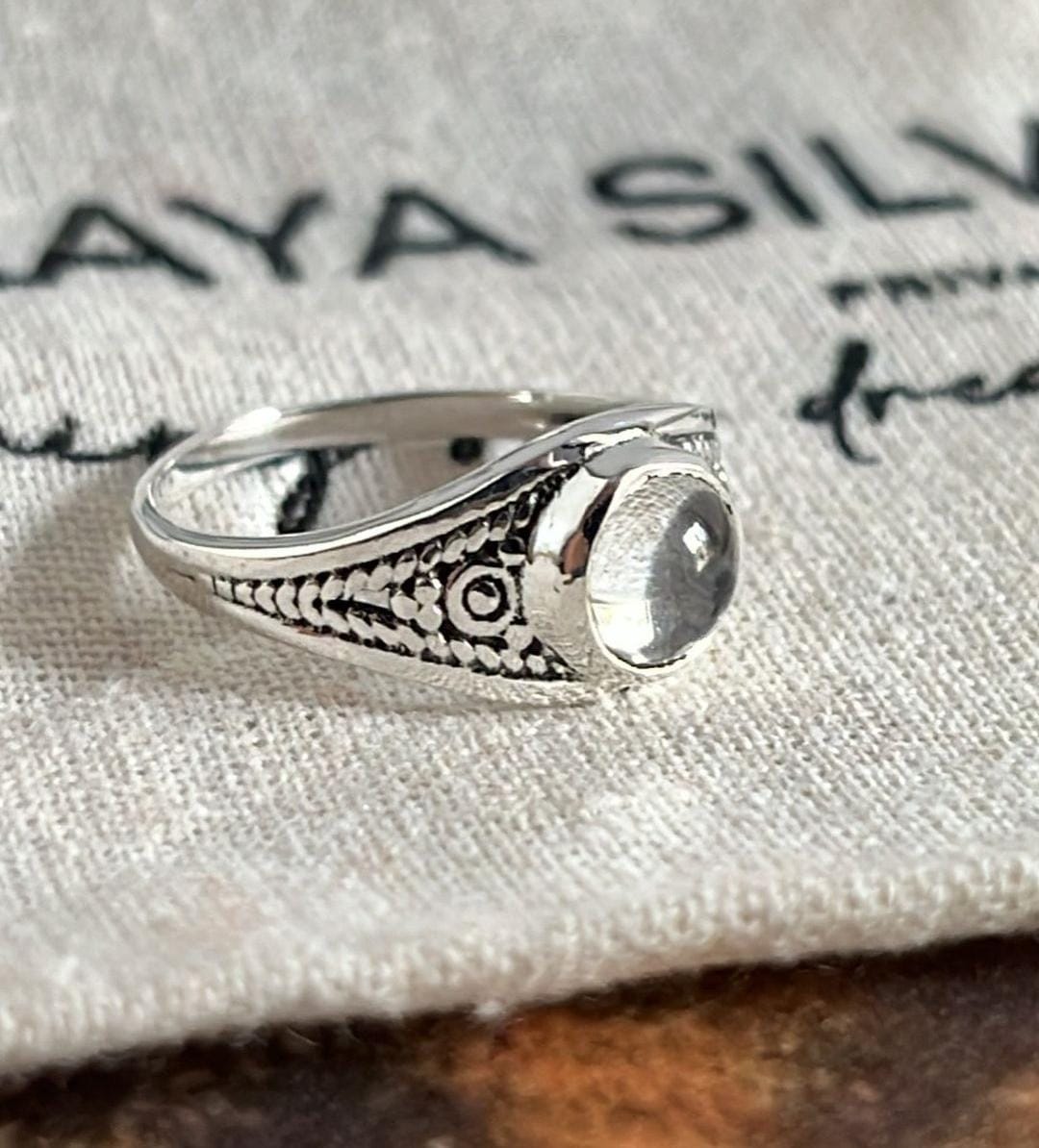 Close-up of clear quartz round silver ring with bohemian design