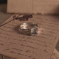 Close-up of clear quartz square cut stone set in a silver ring