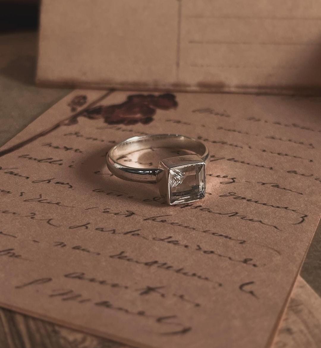 Close-up of clear quartz square cut stone set in a silver ring
