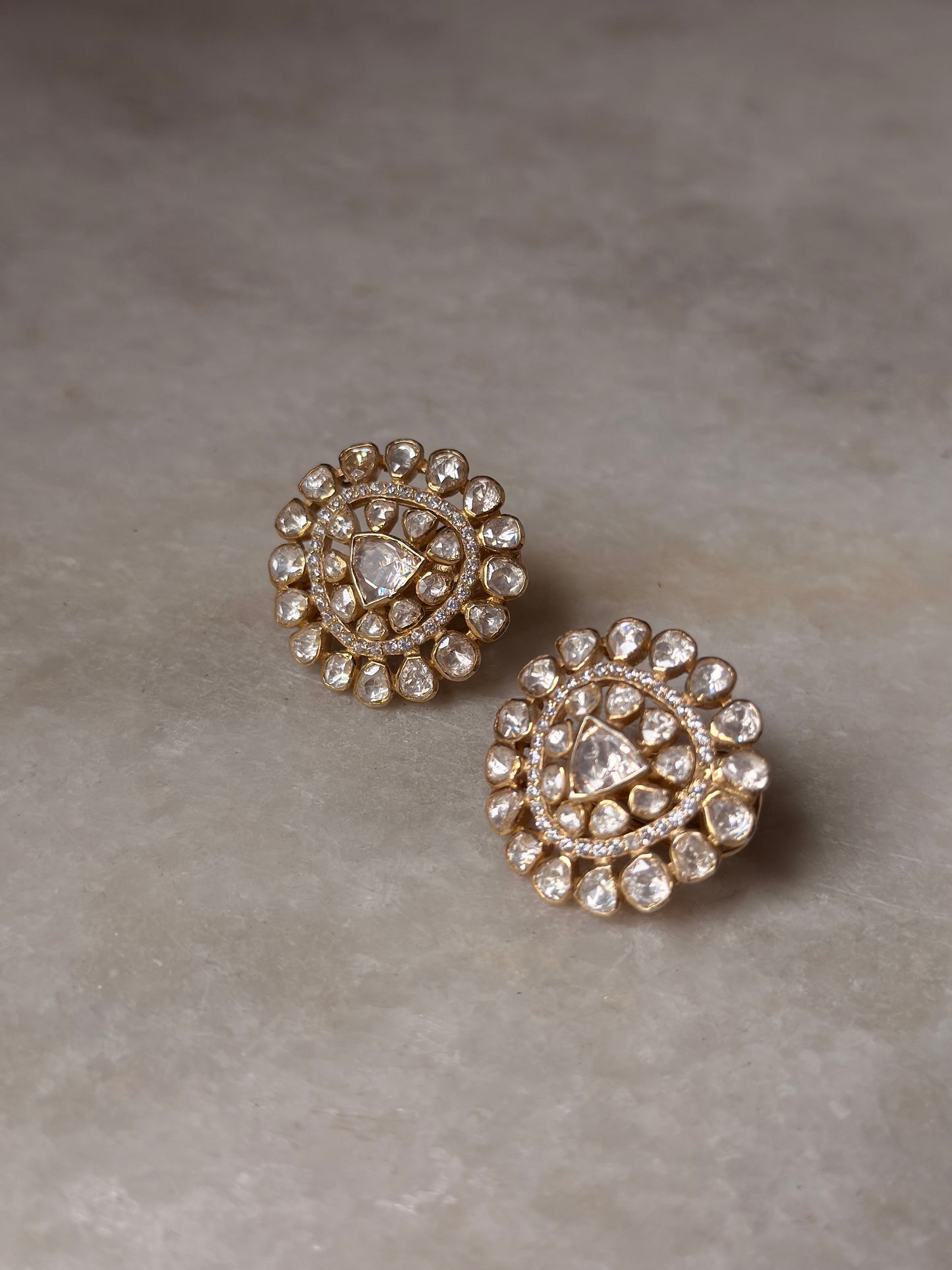 925 Sterling Silver Gold Plated Antique Moissanite Polki Round Studs Earrings on marble surface.