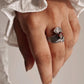 Elegant garnet stone ring with a leaf wrap pattern in silver