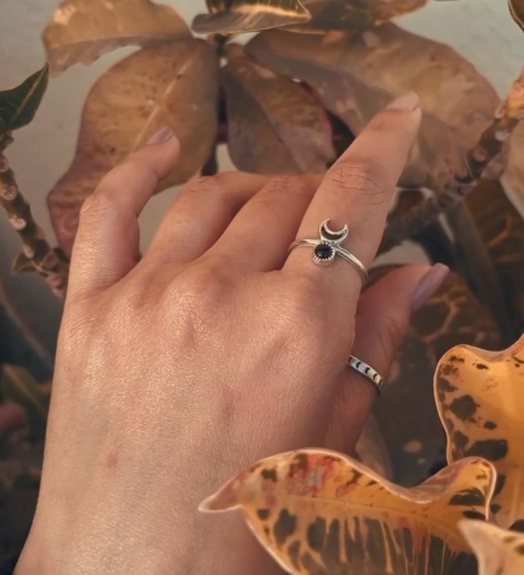 Handcrafted silver ring with a bold black onyx crescent moon motif.