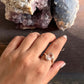 Elegant rose quartz oval ring with cross band details in sterling silver