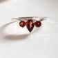 Stunning garnet 3-stone ring in pear and round cut design
