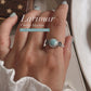 Elegant silver ring with a Larimar stone and cherry blossom detailing