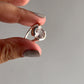 Timeless rose quartz oval ring with cross band design in silver