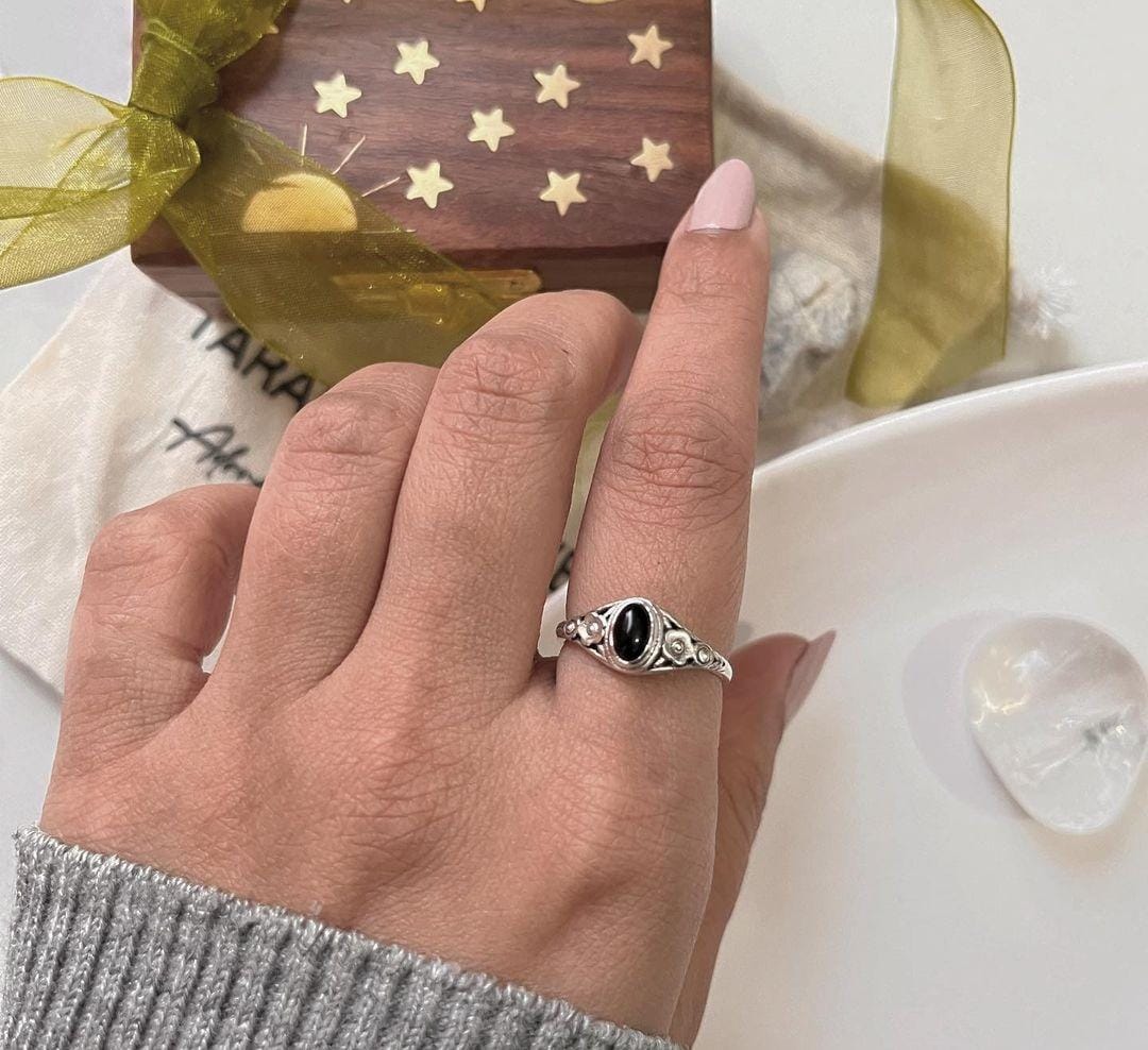 Handcrafted black onyx flower ring in sterling silver with fine detailing.