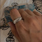 Close-up of a chunky croissant band silver ring with smooth curves