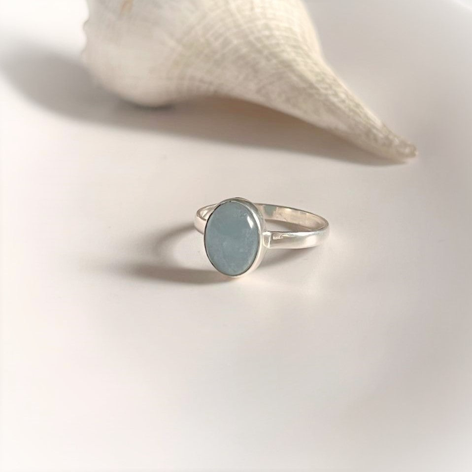 Classic silver ring featuring a natural oval-cut aquamarine gemstone.