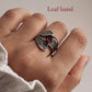 Delicate silver ring with garnet and a twisting leaf wrap design