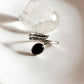Elegant black onyx feather adjustable silver ring with intricate design.