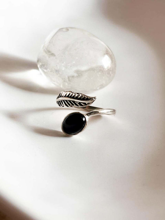 Elegant black onyx feather adjustable silver ring with intricate design.