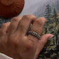 Balinese-style fixed size silver ring with intricate engraving.